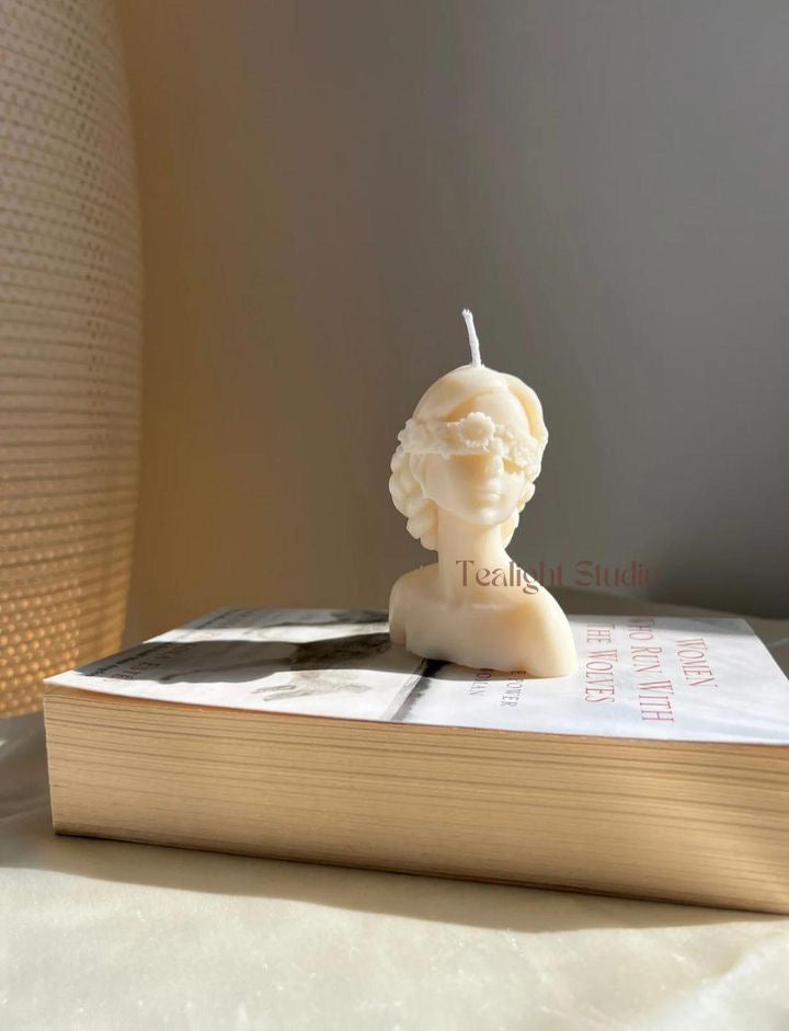 blind folded lady candle