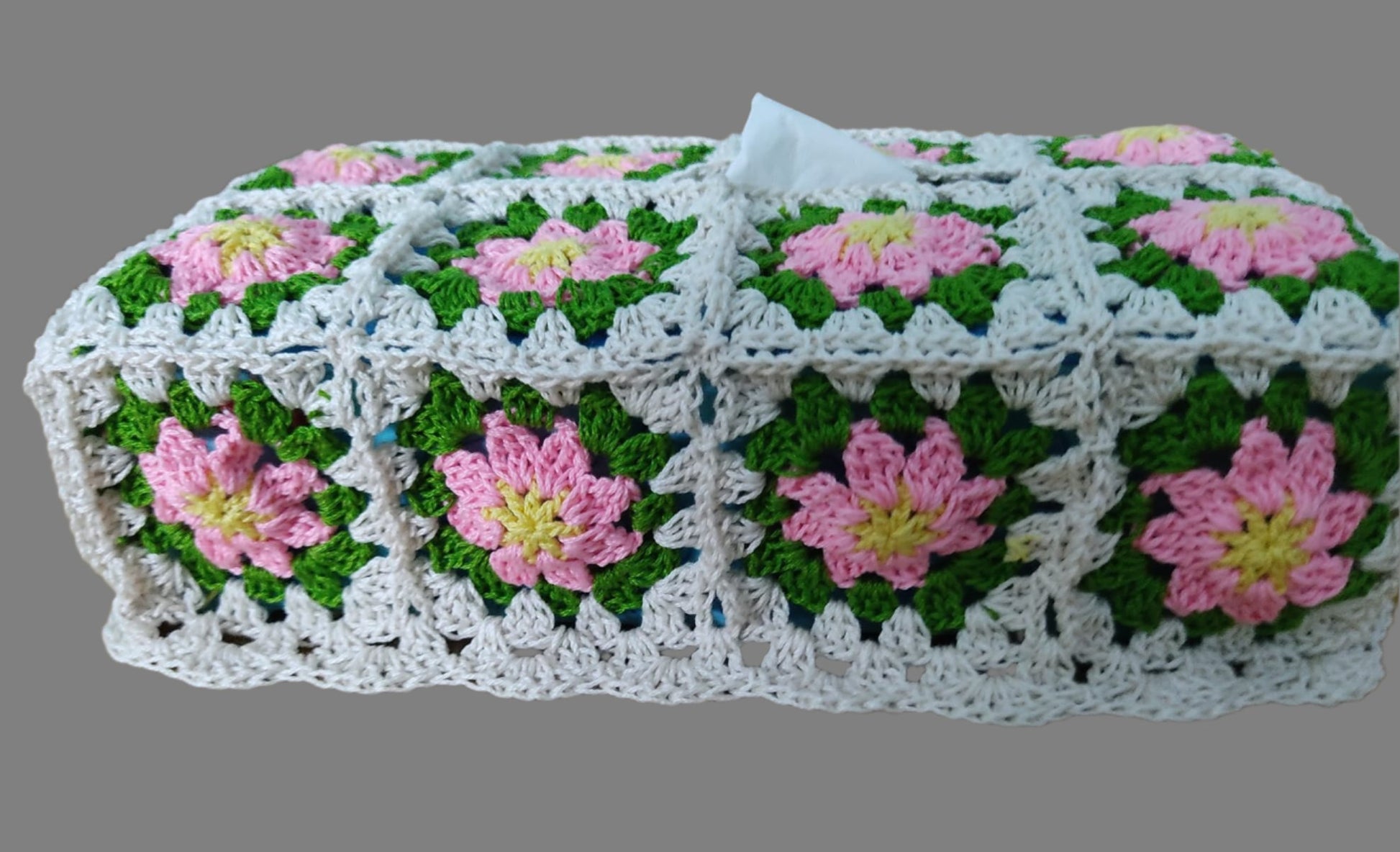 crochet tissue box made of granny squares with pink flowers