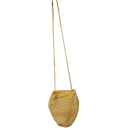 yellow crochet potli bag hung on one string